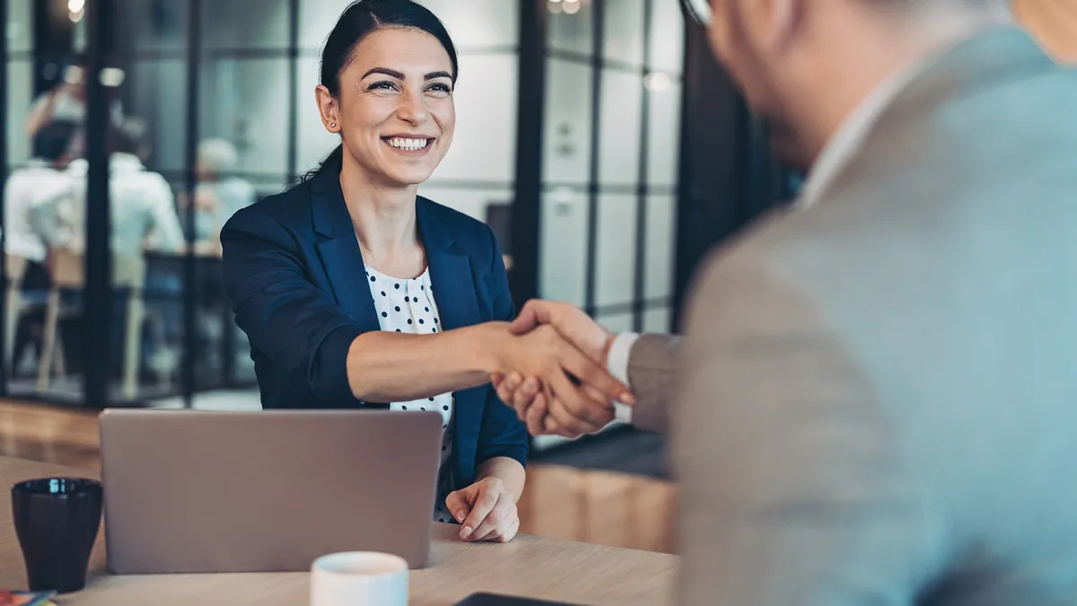 Two business individuals shaking hands