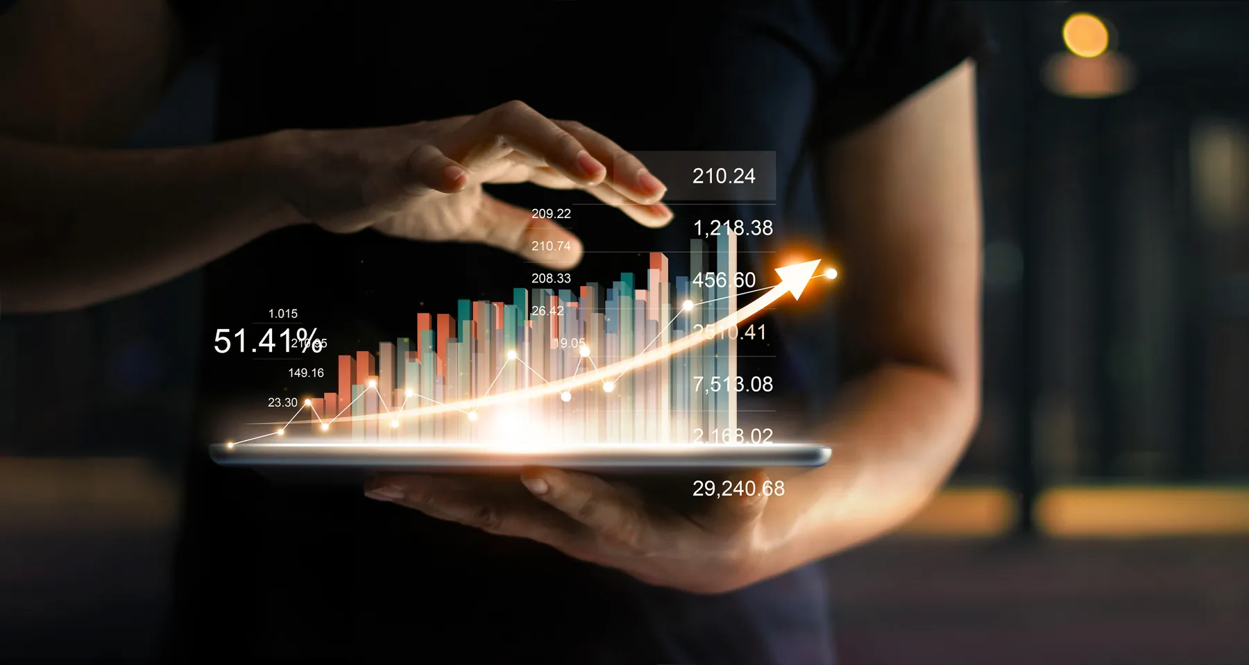 A businessperson holding a table showing a virtual hologram of statistics