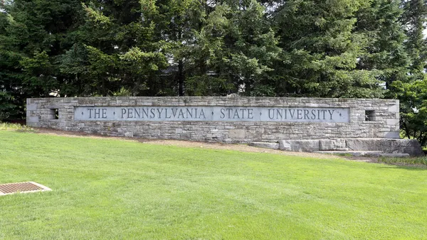 A sign reading "The Pennsylvania State University" at the entrance of the institution's main campus.