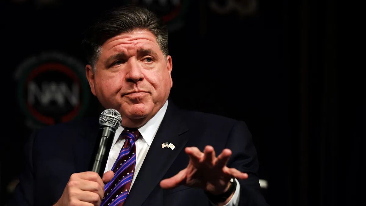 A person holding a microphone while gesturing