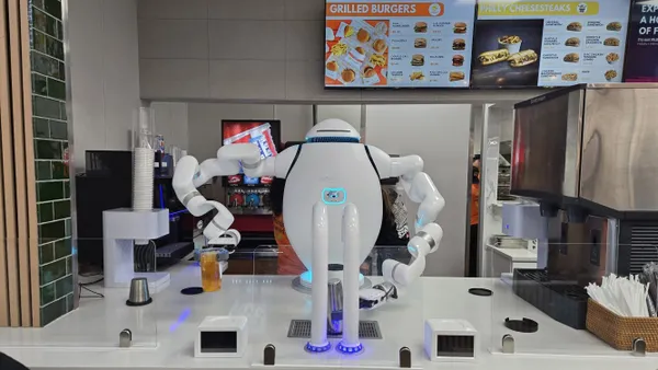 An image of a Richtech Robotics adanced robotic beverage system. The white robot is preparing a drink at a counter top.