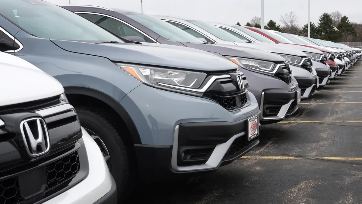 Cars parked outside a Honda dealership.