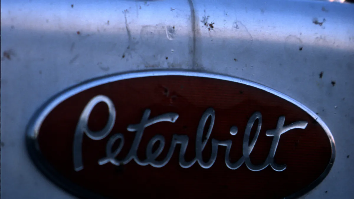 A hood ornament sits atop a Peterbilt tractor-trailer rig.