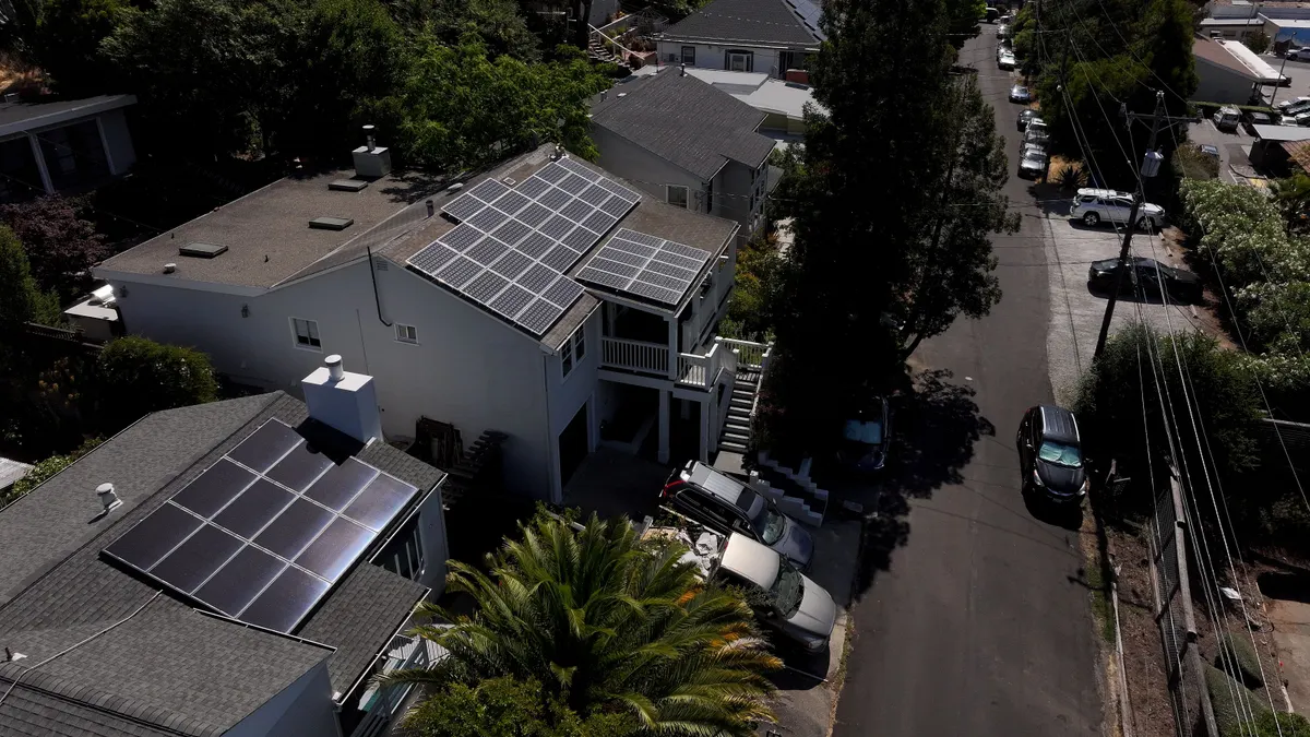 Solar panels lie across residential rooftops.