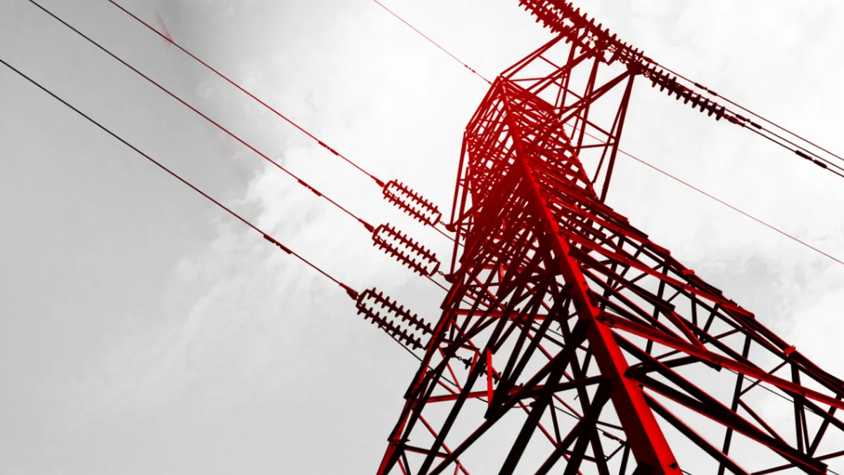 electricity transmission tower with power lines extending into the sky.