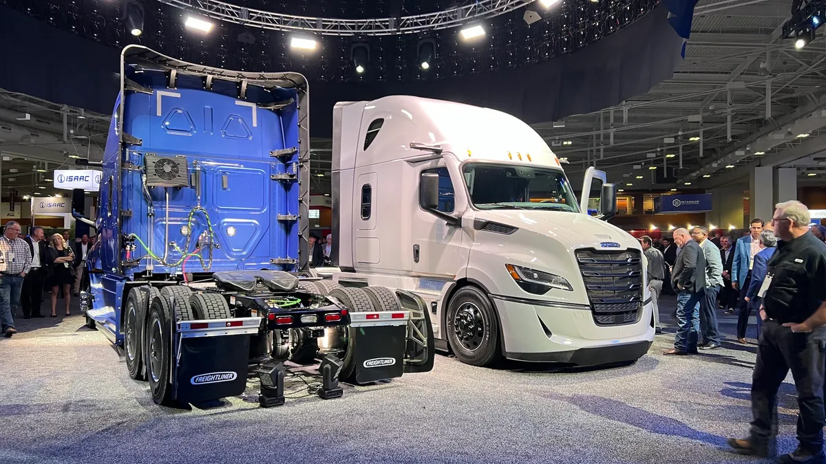 Trucking executives check out a pair of next-generation Freightliner Cascadia trucks at ATA MCE 2024 in Nashville.