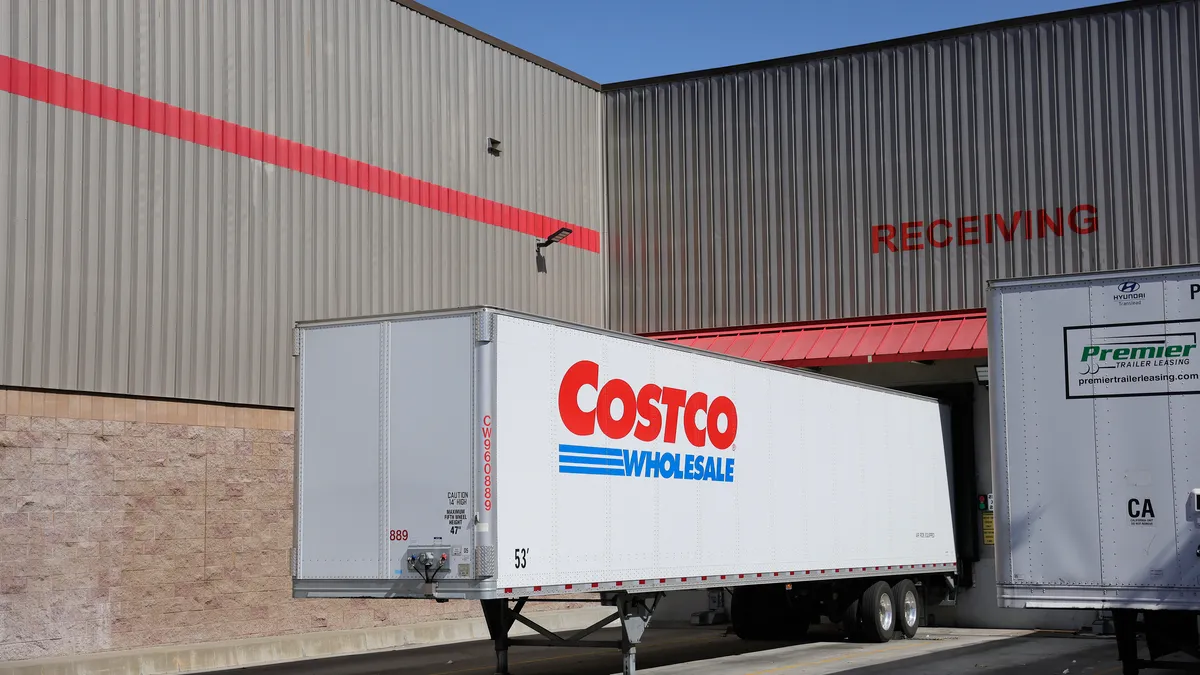 Costco truck is seen in front of a garage with the word "Receiving" above