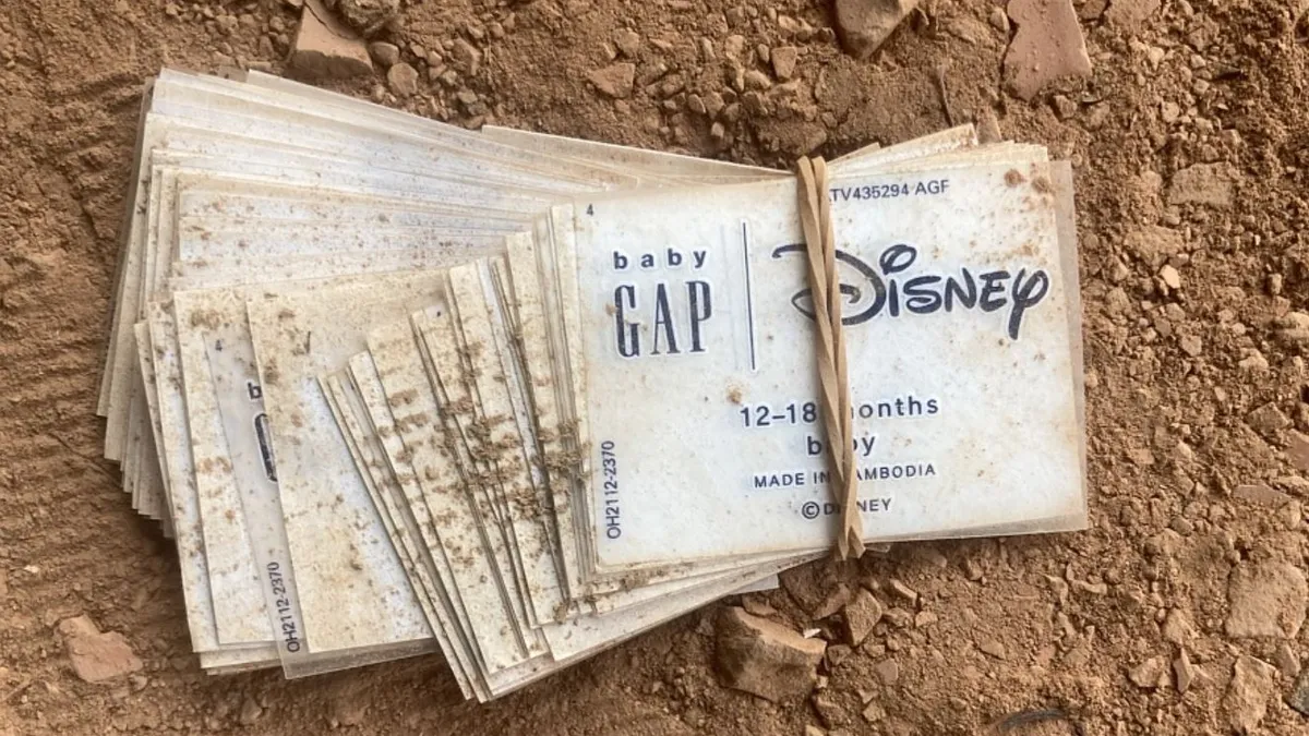 Tags from Gap and Disney are bundled and lie in the dust.