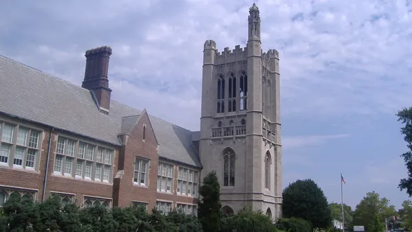 A gothic-style academic building sits in front of a well-manicure green lawn in New Jersey.