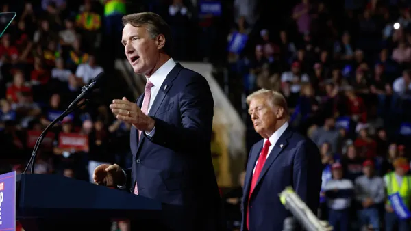 Virginia Governor Glenn Youngkin speaks as now-President Donald Trump listens during a presidential campaign rally three days before the election at the Salem Civic Center on Nov. 2, 2024 in Salem, Virginia.