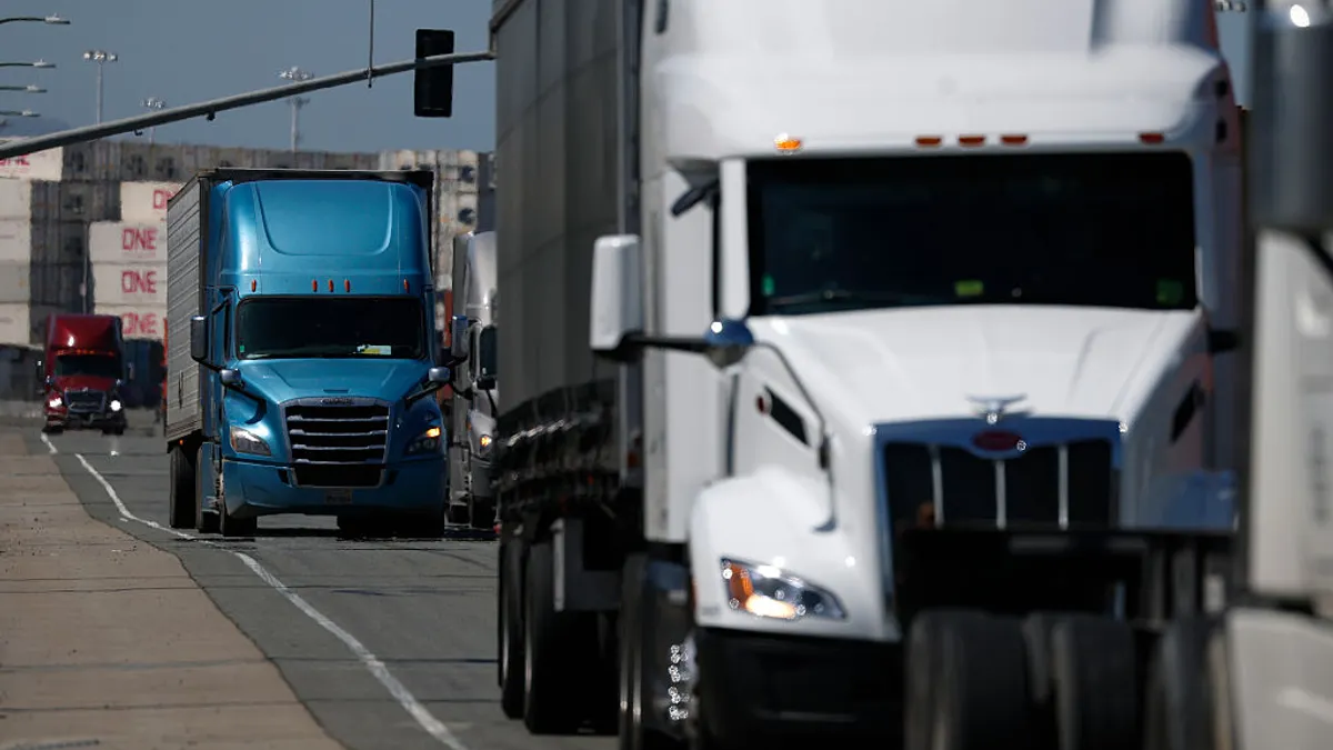 Trucks moving through a port located in Oakland, California.