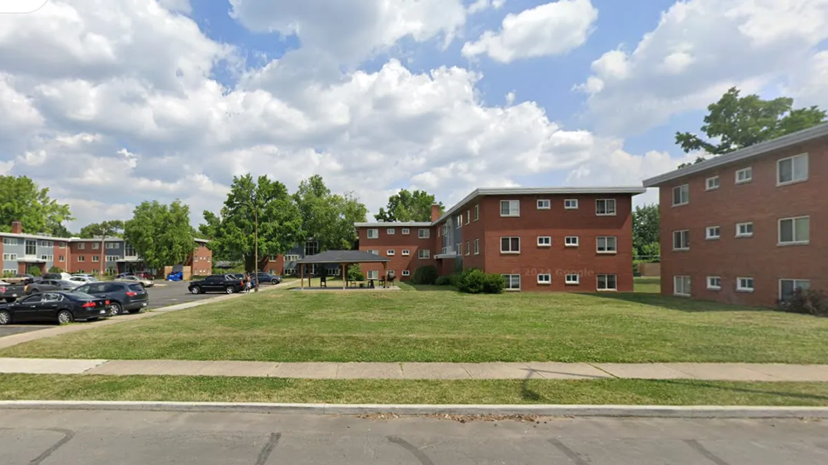 A low-rise apartment property on a sunny day.