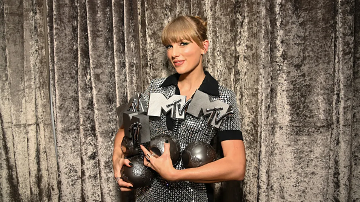 Taylor Swift is seen backstage with the Best Artist, Best Video, Best Pop and Best Longform Video Awards during the Best MTV Europe Music Awards 2022.