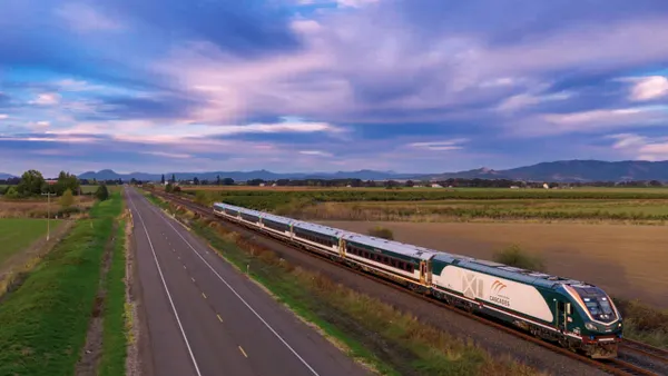 An aerial view of a train moving on tracks.