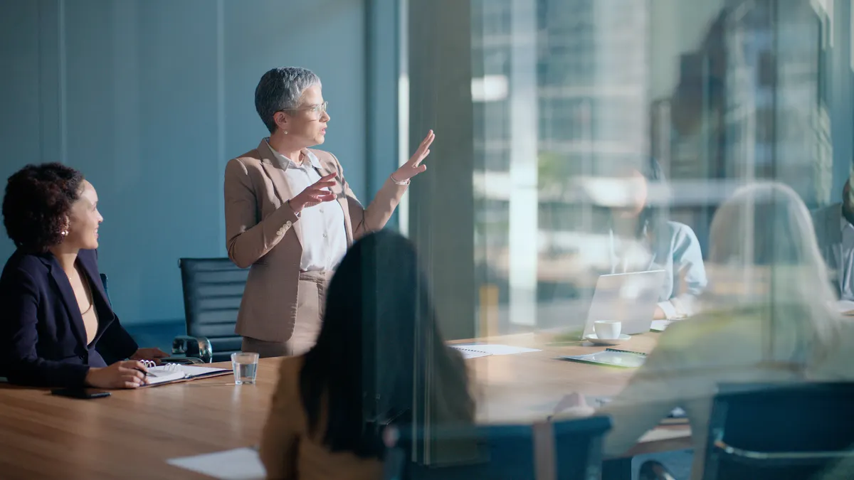 Meeting, business woman and presentation in conference room for leadership