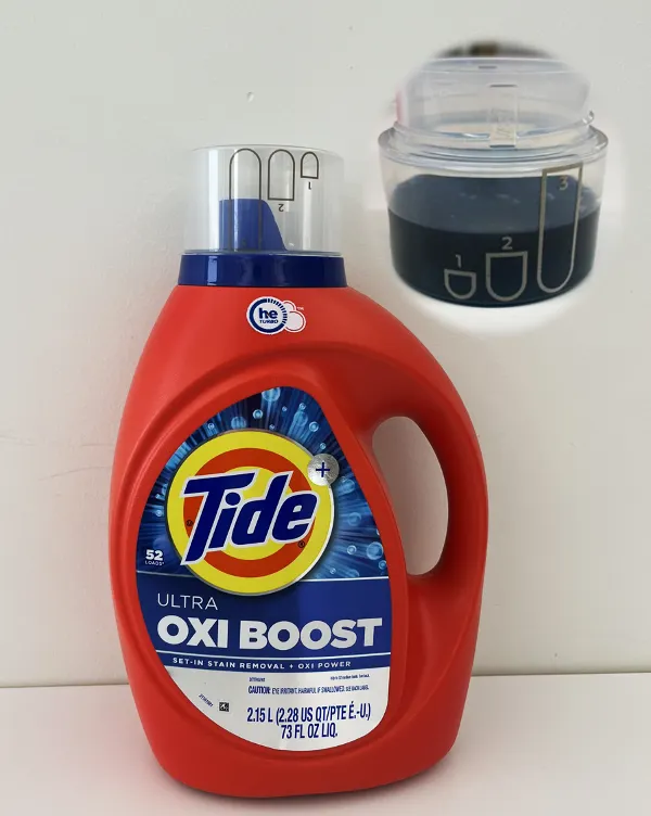 A jug of Tide laundry detergent with a cap that has laser marked dosing information on the side.