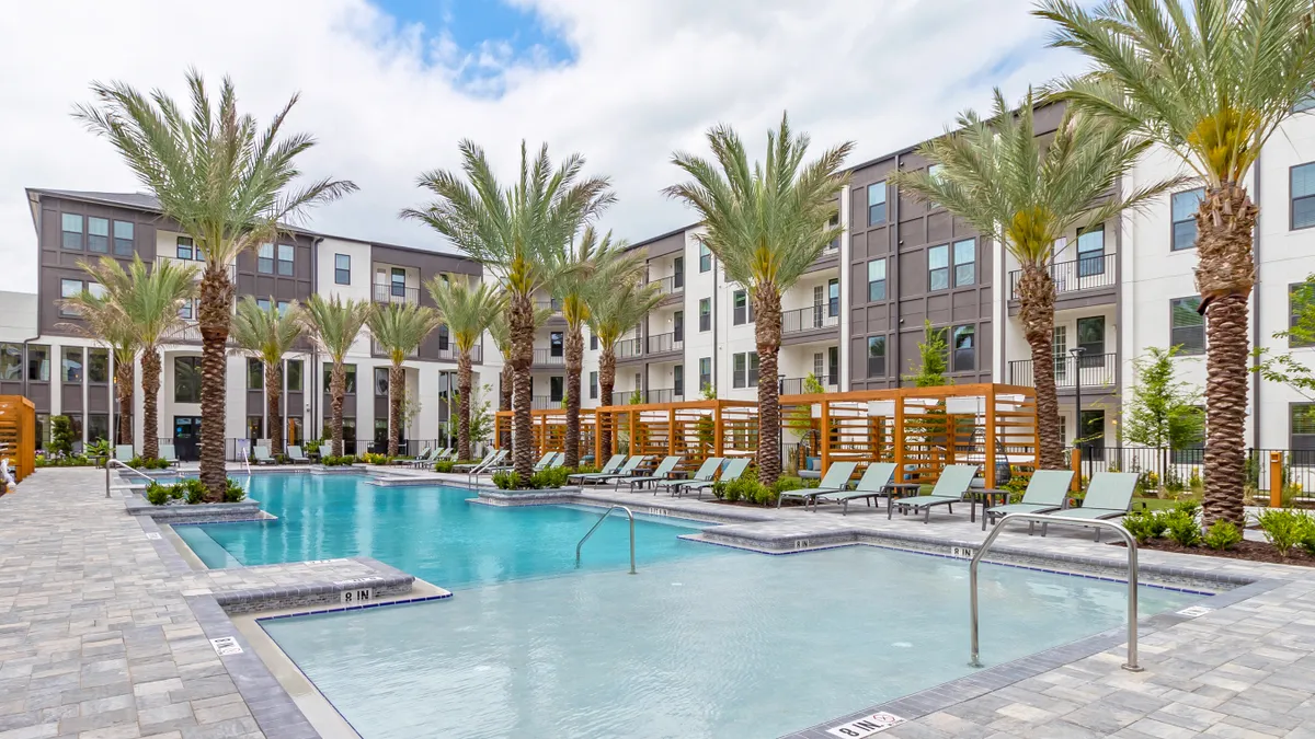 New apartment community with a pool in the foreground.