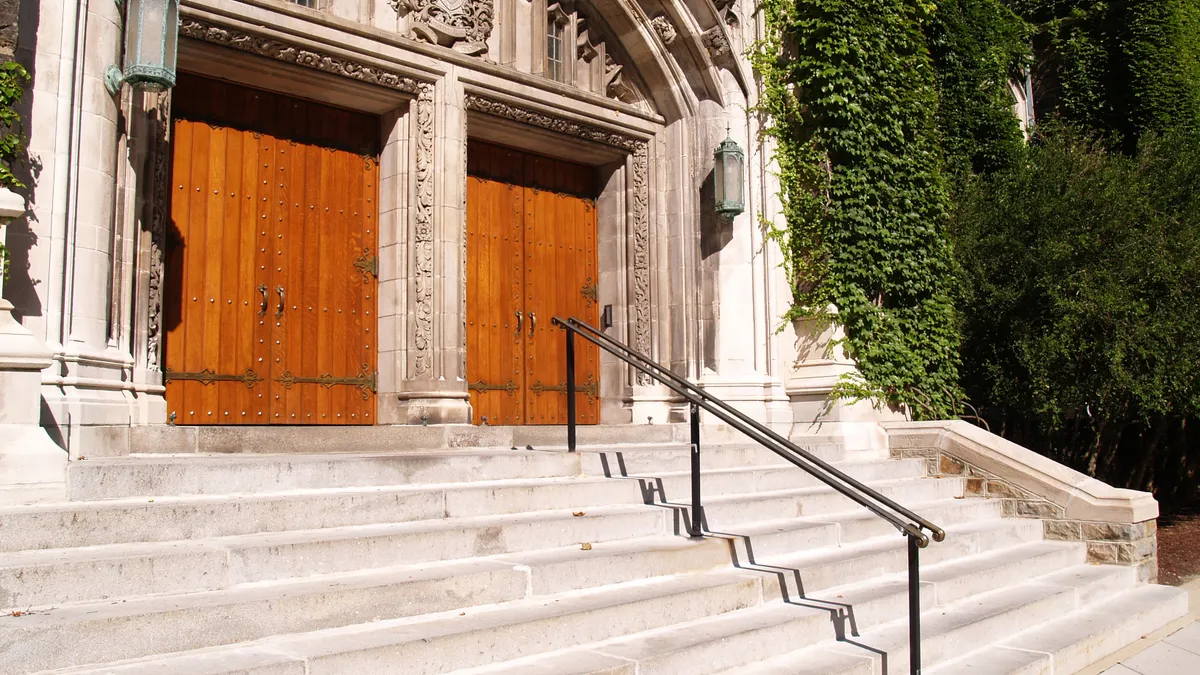 Stairs leading up a traditional-looking academic building.