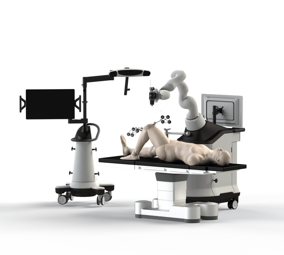 A mounted screen and a surgical robot arm overlook a mannequin on a table.