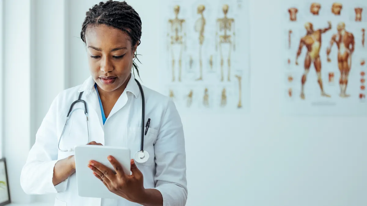 Female doctor using tablet for doing online checkups with her patients