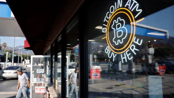 A sign advertises a Bitcoin ATM