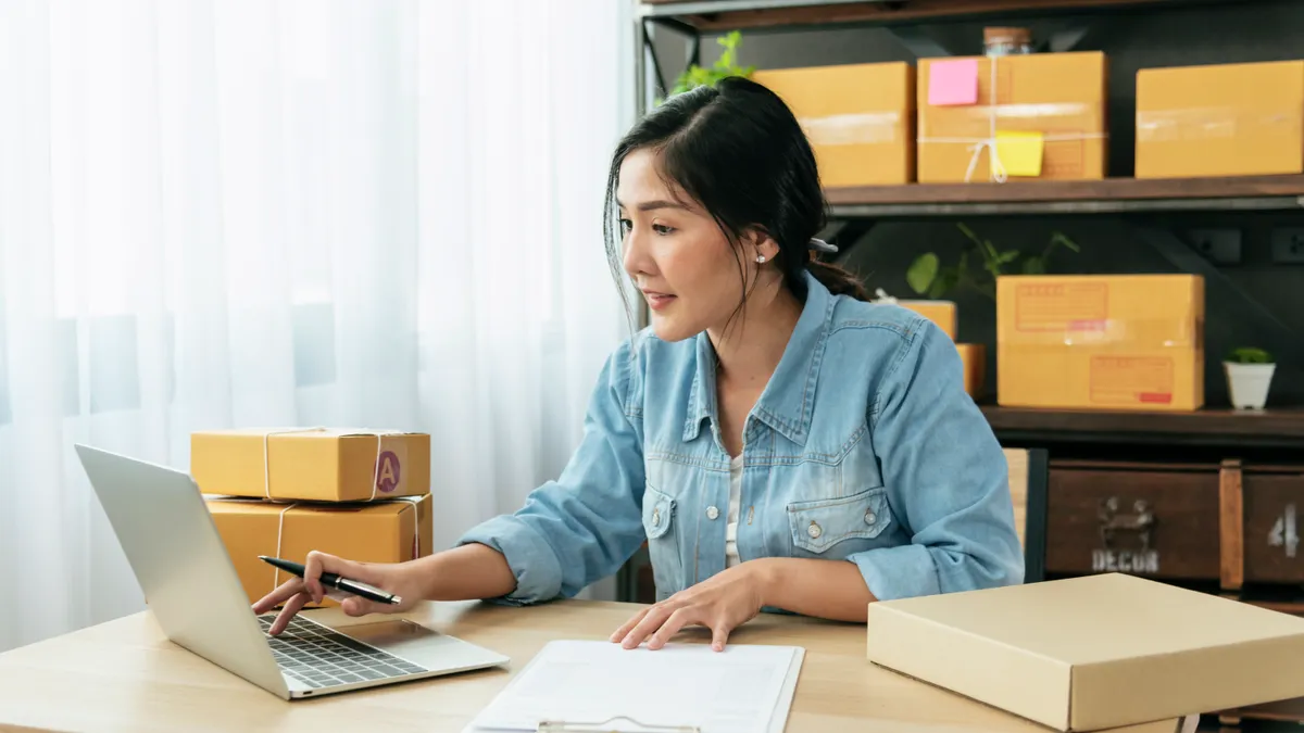 Young woman working on the computer at home.