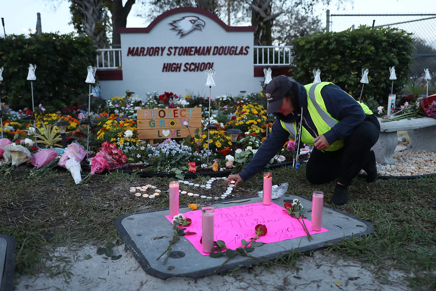 A school crossing guard pays her respects at a memorial setup for those killed on February 14, 2018, at Marjory Stoneman Douglas High School in Parkland, Florida.