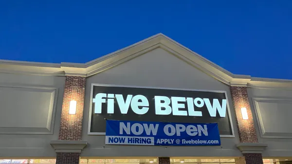 A Five Below storefront at dusk with a now open banner