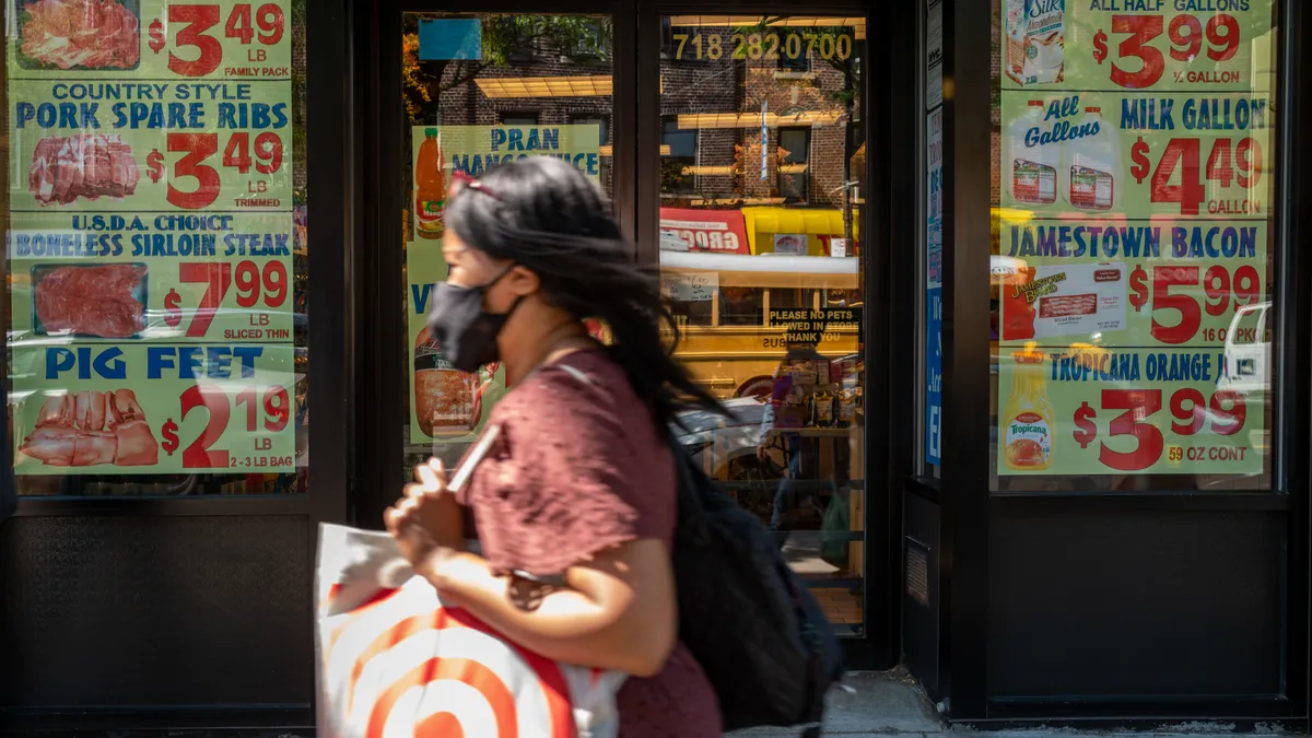 Person walks past grocery store