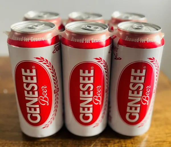 A six-pack of red and white Genesee beer cans in a plastic carrier.