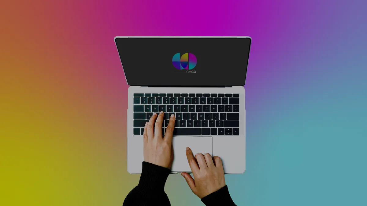 Two hands working on a modern laptop