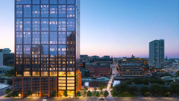A rendering of a tall, wood-covered building looms in the foreground.
