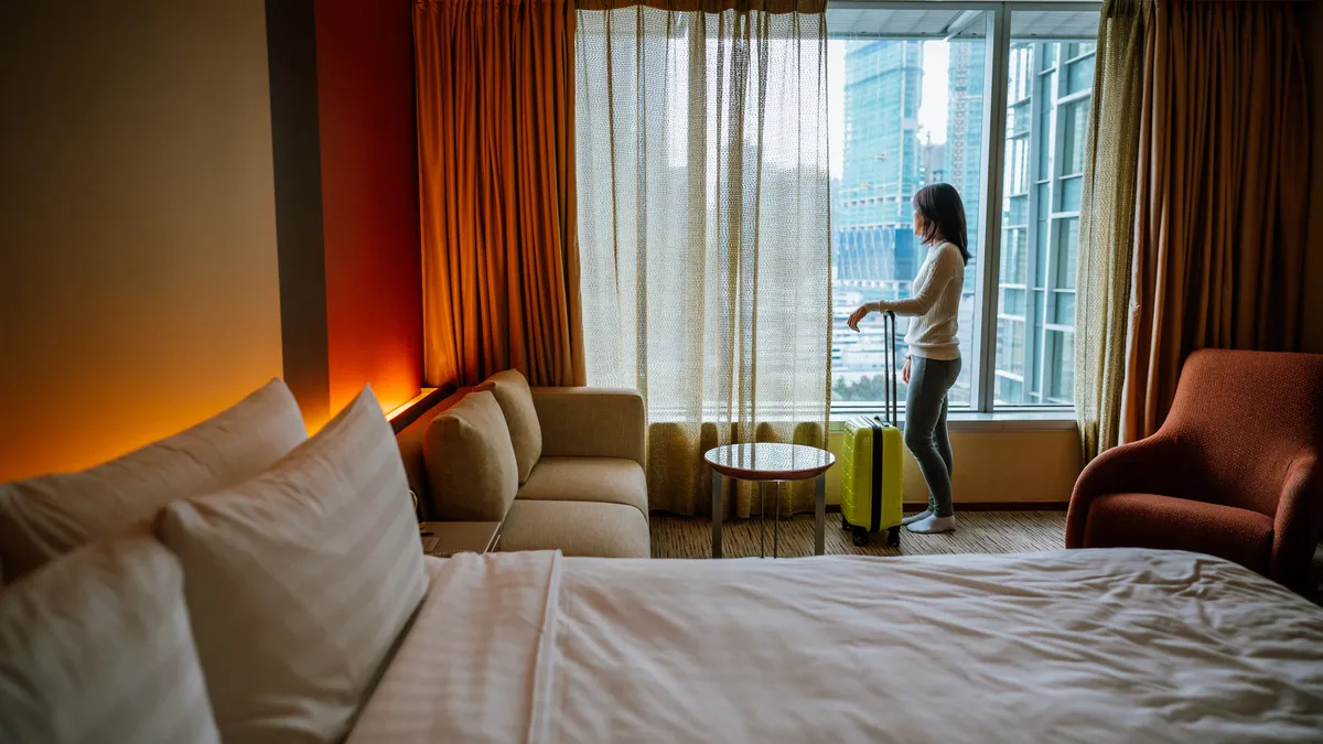 Hotel guest looks out window