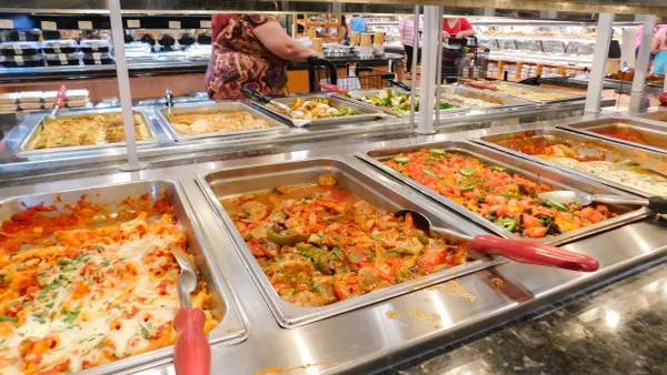 Hot and ready meals on display buffet style at grocery store