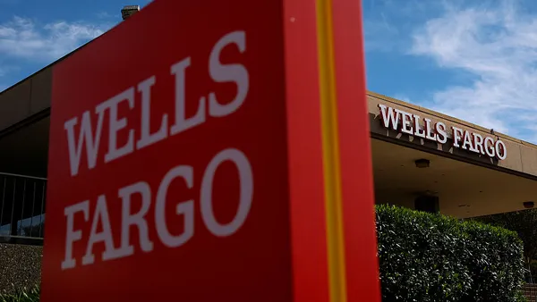 Wells Fargo signage outside a building with "Wells Fargo" on it.