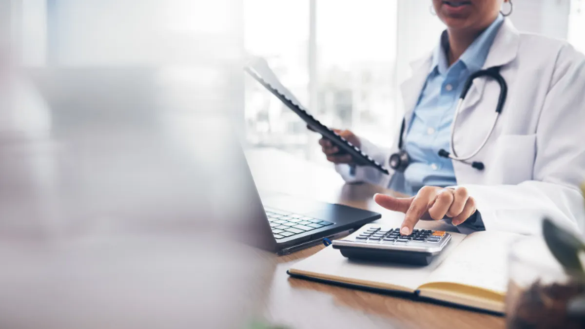 Doctor using a calculator
