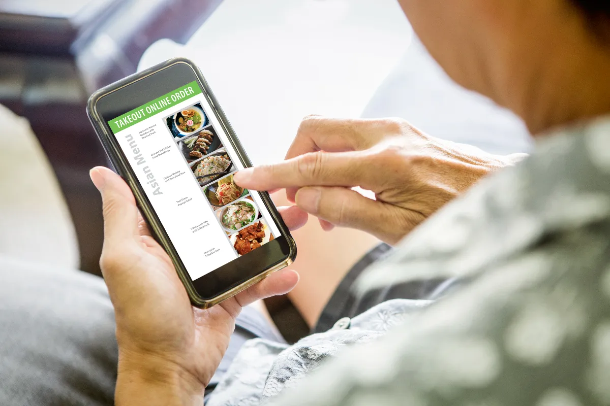 Ordering takeout and delivery convenience food from an online Asian restaurant delivery meal from a smart phone.