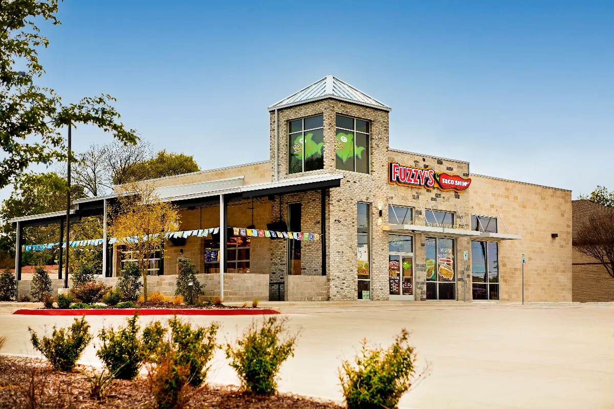 An image of a building with Fuzzy's Taco Shop logo.