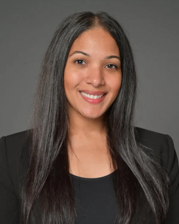 Headshot of a woman with long dark hair.