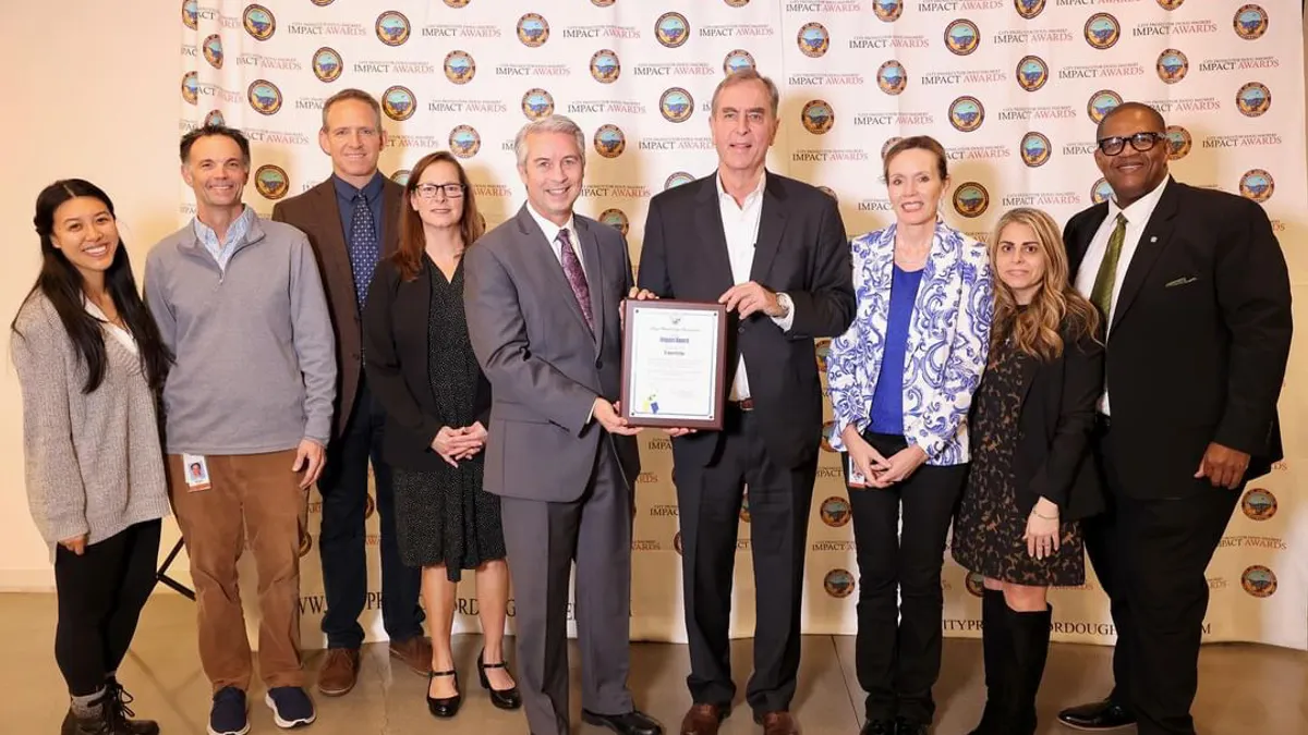 a group of diverse people receiving an award