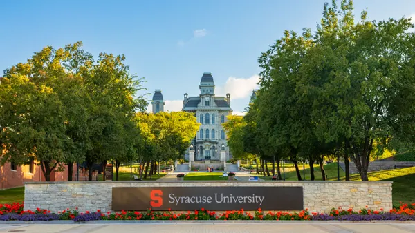 A campus building and a sign reading "Syracuse University."