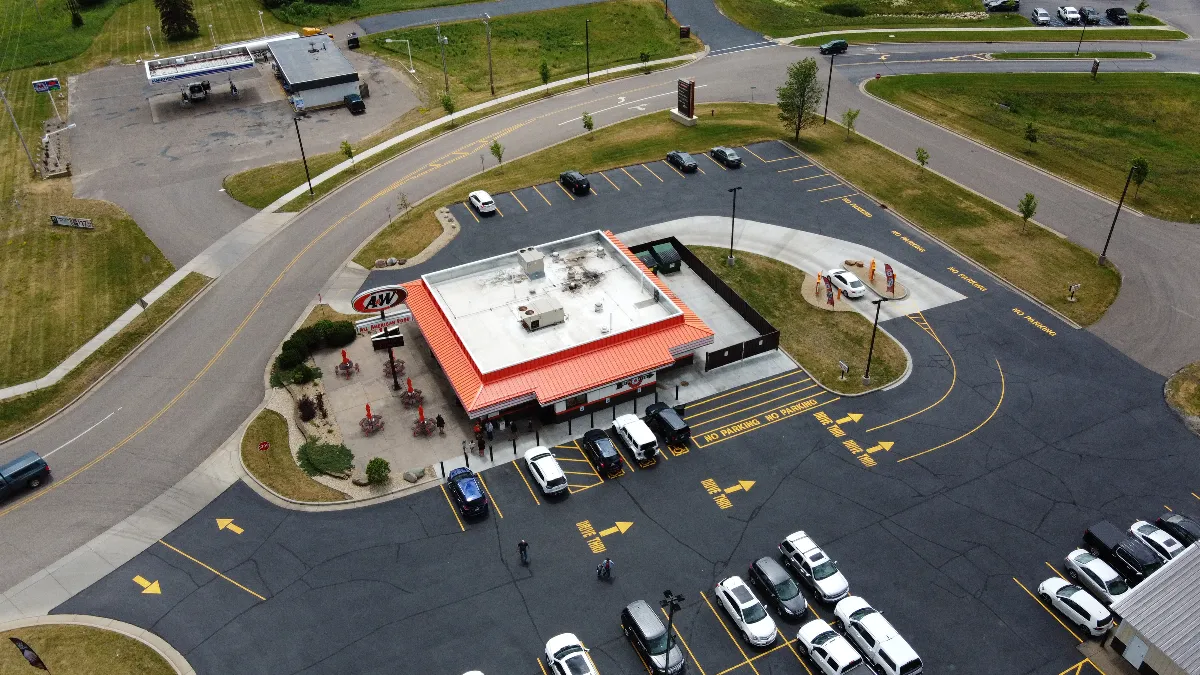 An aerial image of an A&W double drive-thru restaurant