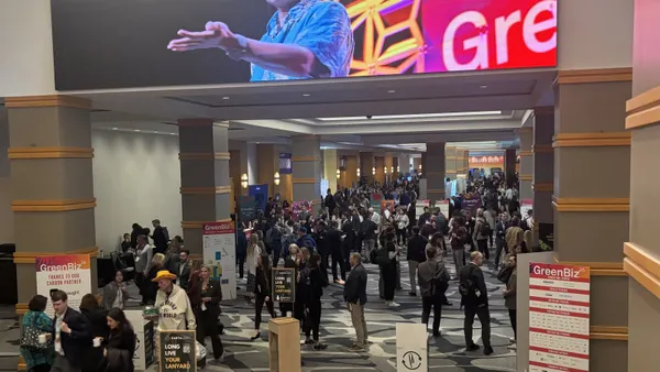 Sustainability professionals in a hotel's conference wing with GreenBiz26 signage scattered throughout