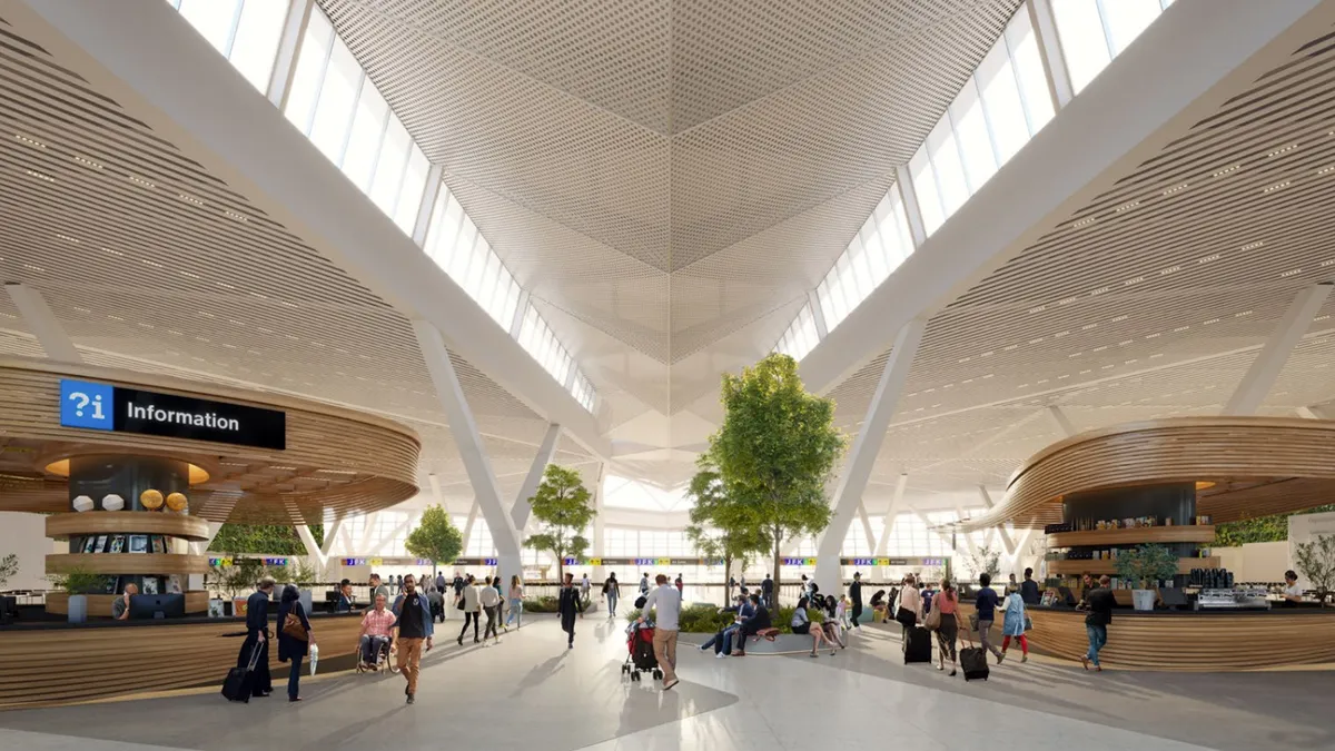 People move through an open terminal with a lofty white ceiling and smooth wooden kiosks.