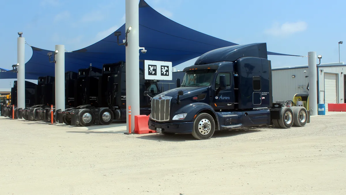 Aurora trucks at its Palmer, Texas, terminal under an outside canopy.