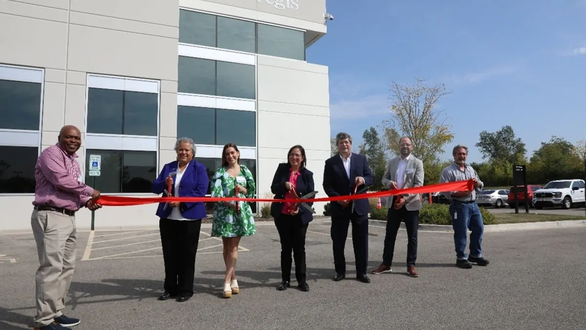 7 people smile and cut a red ribbon in front of Pregis' new facility in Elgin, Illinois, on Sept. 19, 2025.