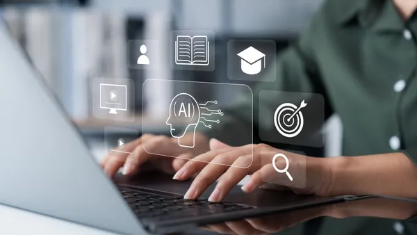 A person types on a laptop as an AI graphic hovers above the keyboard.