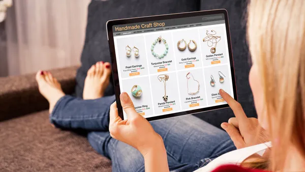 A woman browses jewelry on her tablet.