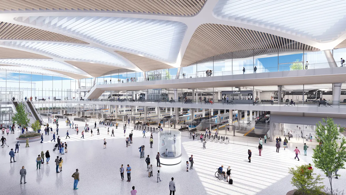 Rendering shows the interior of the train hall building with an expansive open space with people walking around under sweeping white ceilings.