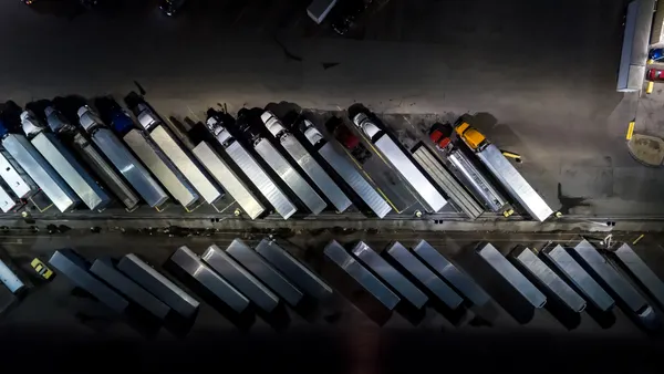 Aerial shot looking directly down on a row of trucks parked at a truck stop near Albuquerque, New Mexico at night.
